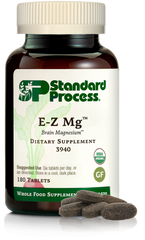 Image of E-Z Mg bottle next to tablets of magnesium supplements.