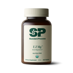 Image of E-Z Mg bottle next to tablets of magnesium supplements.